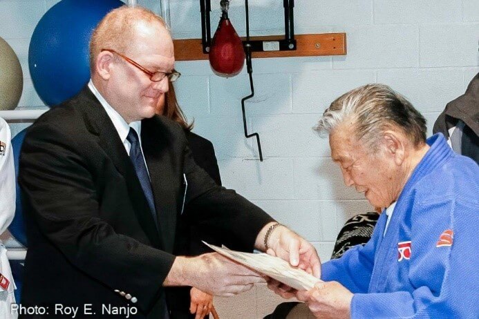 Roy Englert Awarding Jimmy Takemori with Honorary IJF-A Referee certificate. 